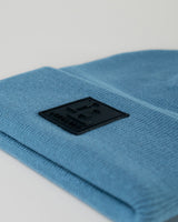 Close-up of 3D rubberized LYFTLYFE logo stitched on blue toque.