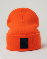 Front-facing orange LYFTLYFE beanie standing upright with bold 3D patch.