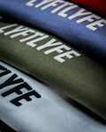 Close-up of the Contour Tee’s 3D rubberized Lyftlyfe logo, showcasing high-quality craftsmanship and textured branding in multiple colorways.