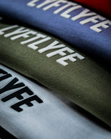 Close-up of the Contour Tee’s 3D rubberized Lyftlyfe logo, showcasing high-quality craftsmanship and textured branding in multiple colorways.