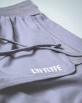 Close-up of logo placement on left side of purple HIIT women’s shorts.