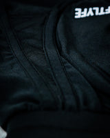 Detail of curved hem and stitching for full mobility and airflow of women's black gym shorts. 