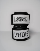 Pair of LYFT wrist wraps stacked, showing "DOMINATE ADVERSITY" and "LYFTLYFE" branding.
