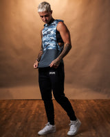 Women’s athletic sleeveless hoodie in blue camo, shown from the side, showcasing a relaxed hood and moisture-wicking technology.