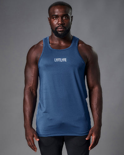 Mens tank top in blue. Rubberized white logo in the middle of the chest. 