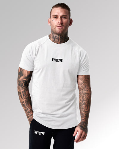 White LYFTLYFE contour t-shirt with black logo on light grey. 