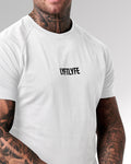 Close-up of the 3D rubberized LYFTLYFE logo on the chest of the white Contour Men’s T-Shirt, adding a premium touch.