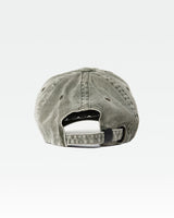 Acid wash dad cap in green from behind with faded finish and back opening.
