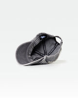 Inner view of grey acid wash hat with Dominate Adversity slogan lining.