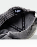 Detailed interior shot of grey dad hat with Dominate Adversity taping and tag.